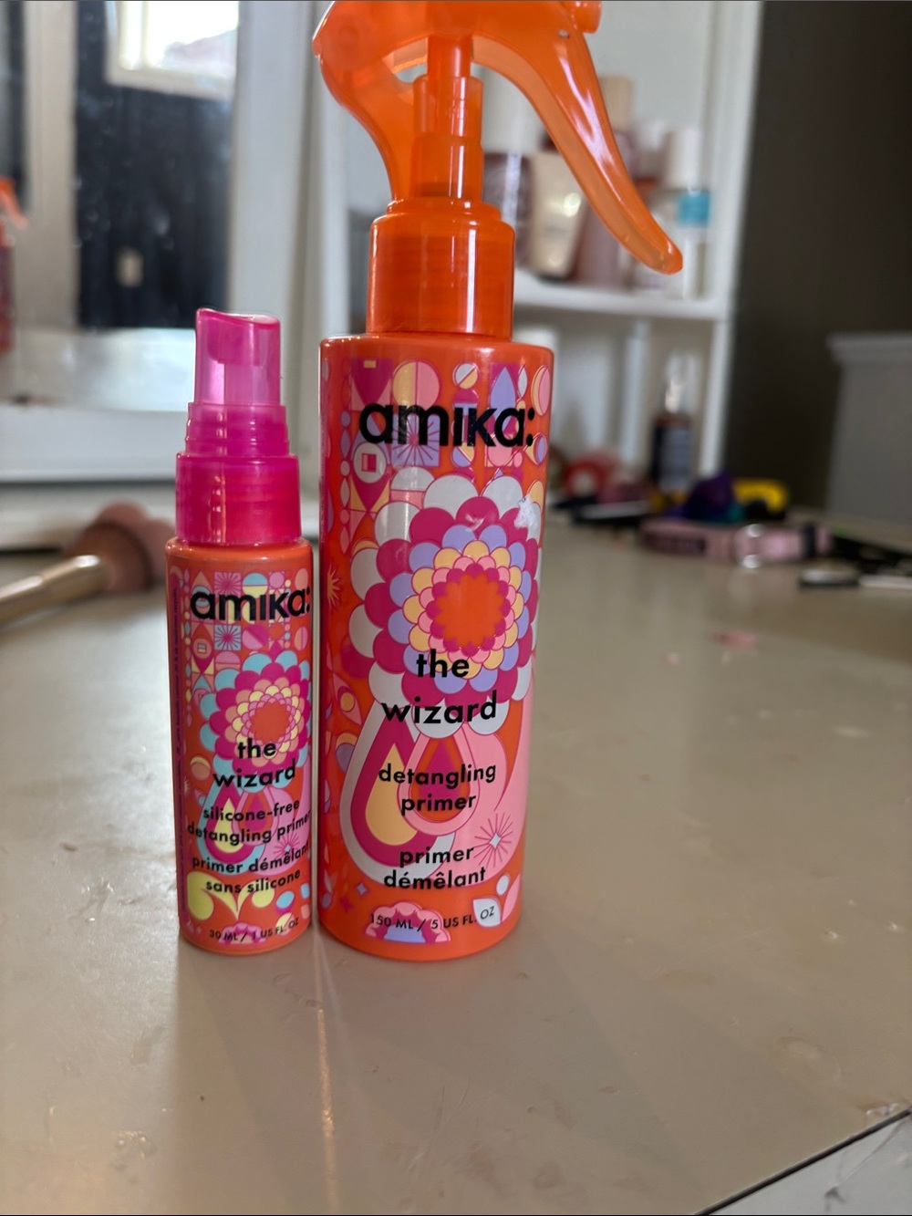 amika The Wizard Detangling Primer Spray - Orange and Pink Bottle